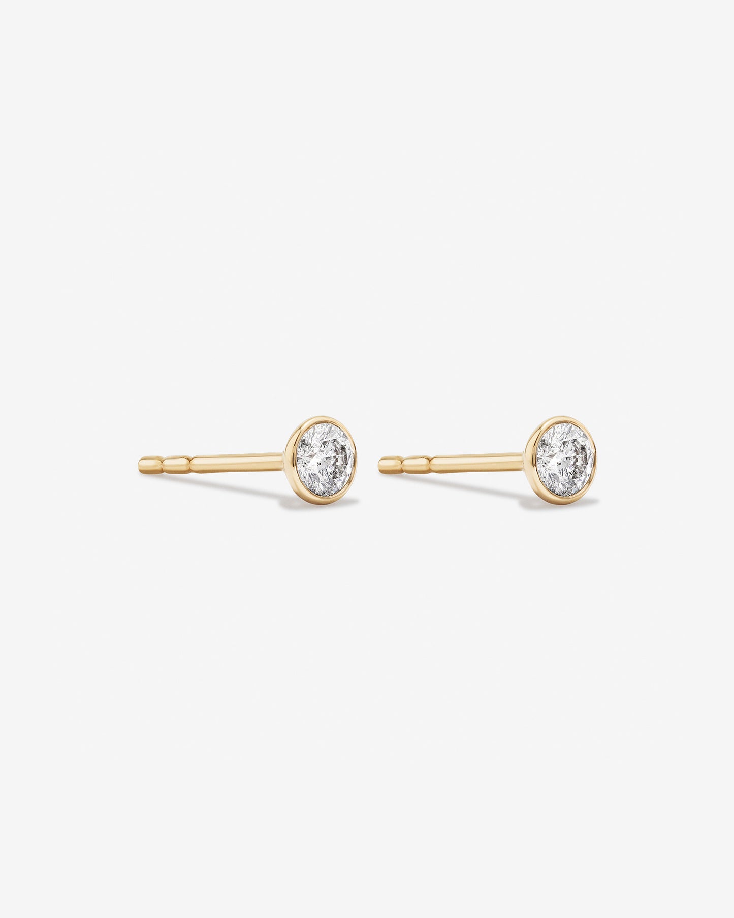0.25 Carat TW Round Brilliant Diamond Solitaire Bezel Set Stud Earrings in 18kt Yellow Gold