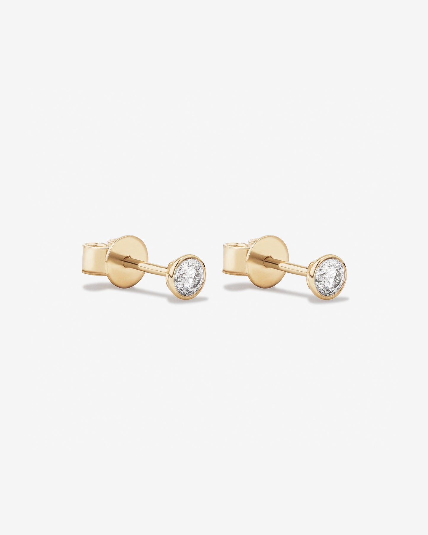 0.25 Carat TW Round Brilliant Diamond Solitaire Bezel Set Stud Earrings in 18kt Yellow Gold